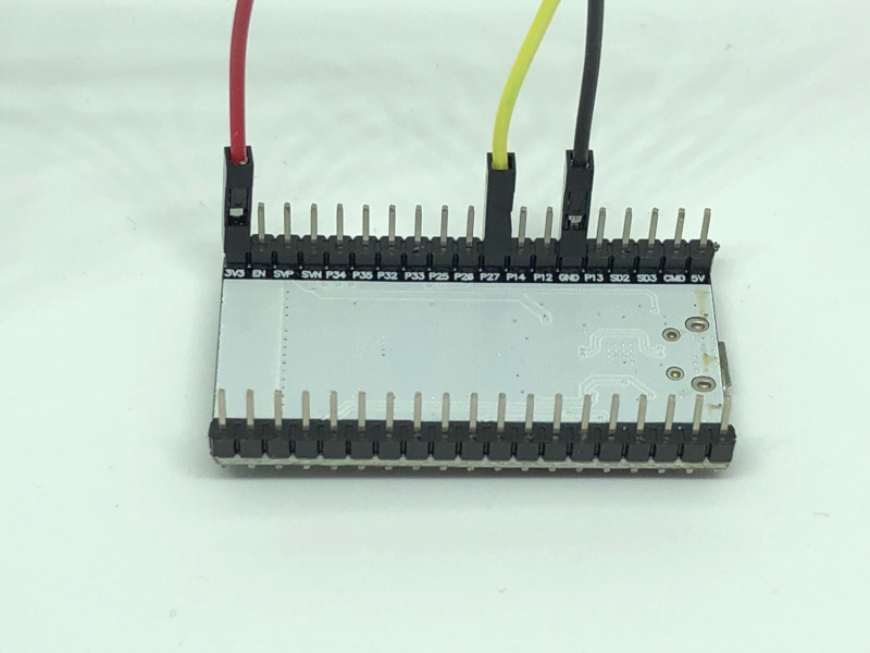 ESP32 with gpio wires connected to 3v3 gnd and gpio27 pins