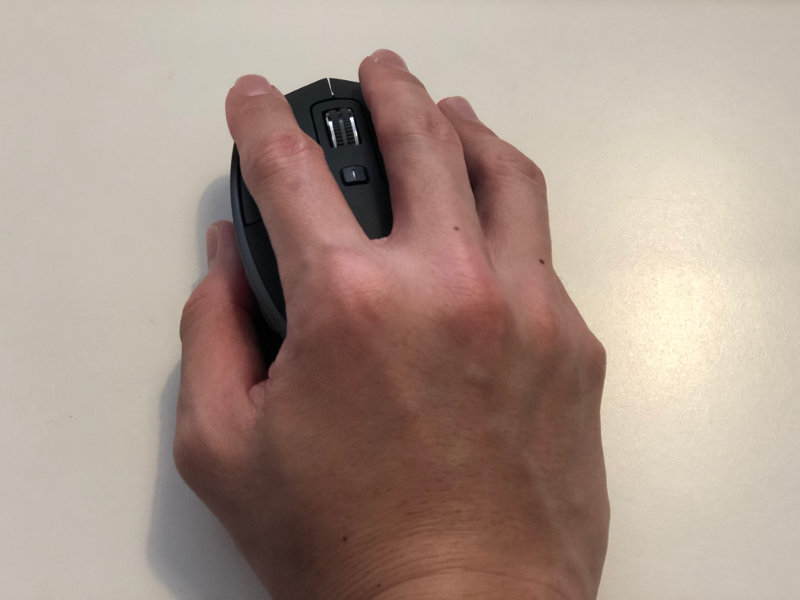 Gripping Logitech MX Master 2S wireless mouse with my right hand