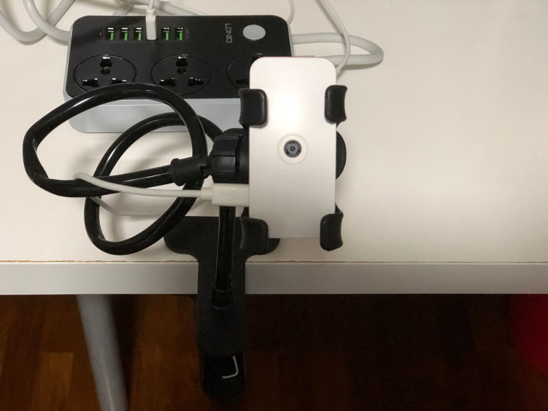 Raspberry Pi Zero W CCTV held by mobile phone holder clamped to desk