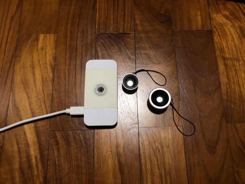 Raspberry Pi Zero W with magnetic adapter ring 0.67x wide angle lens and fisheye lens on wooden floor