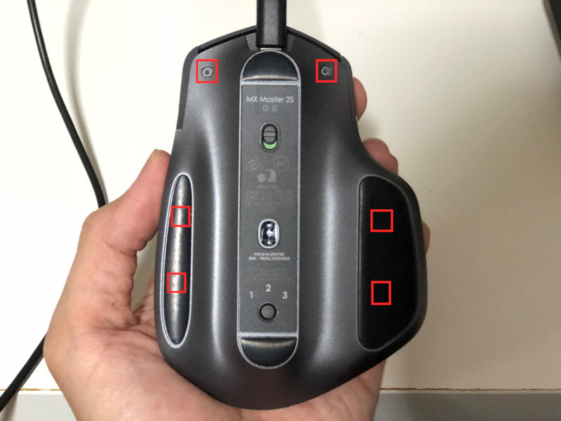 Underside of Logitech MX Master 2S wireless mouse with screw locations highlighted