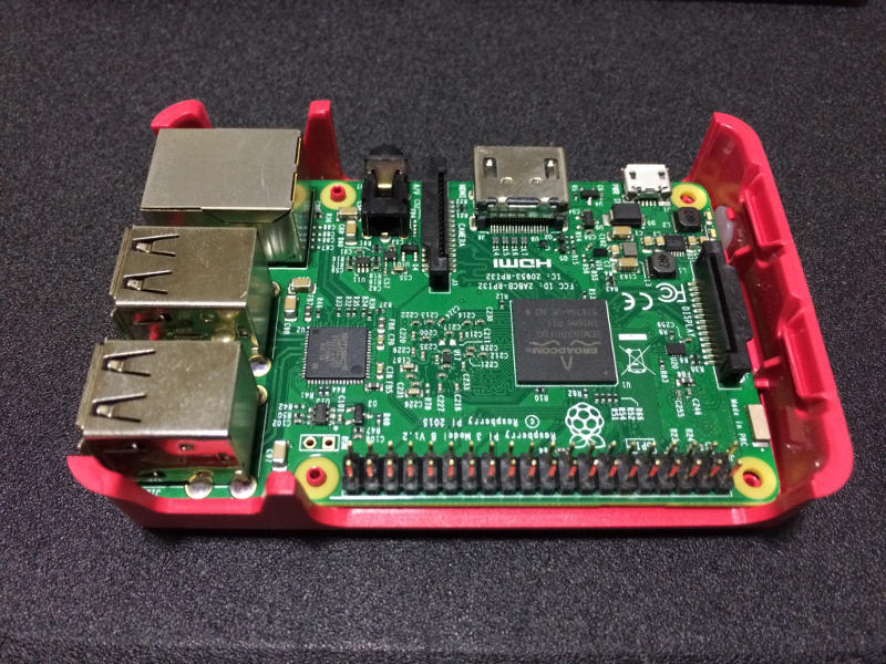 Raspberry Pi 3 board fitted into red base of Official Case