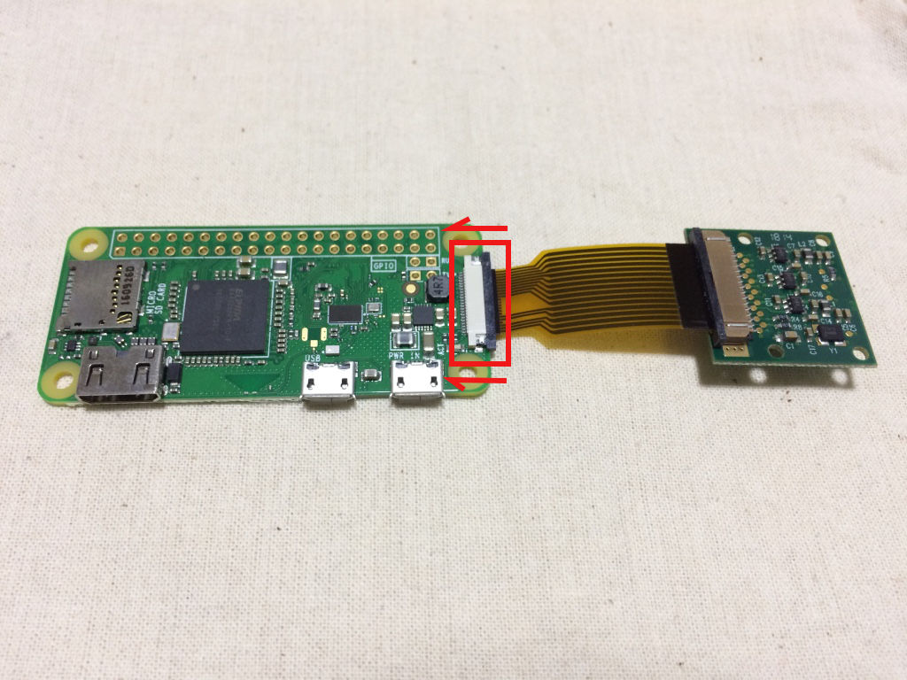 Raspberry Pi Zero W board with camera cable slotted into csi connector and clip fastened