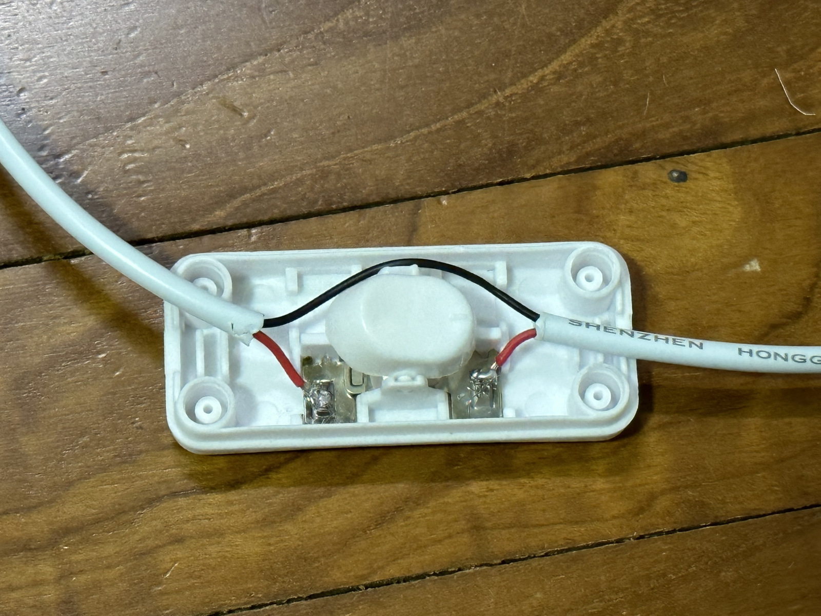 red wires soldered onto metal conductors of inline cord switch